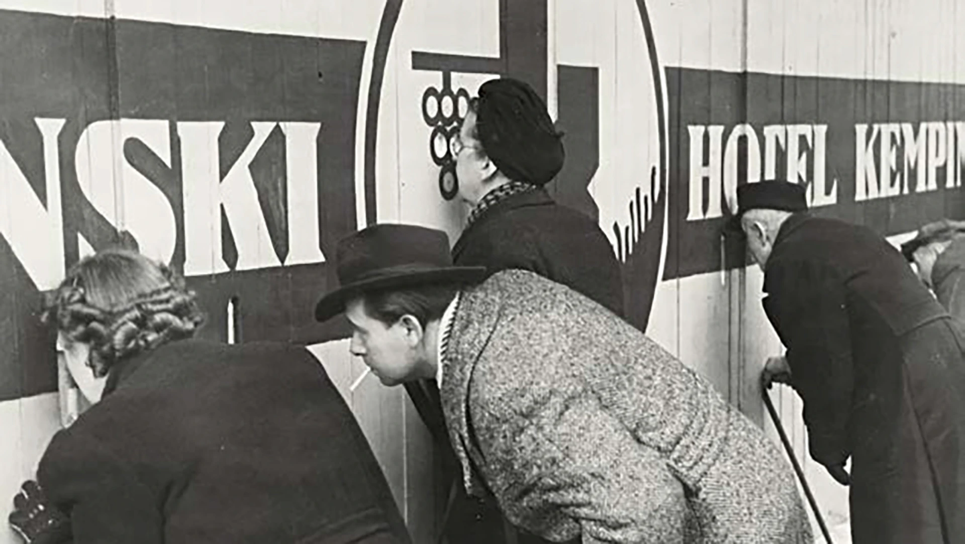 Historic Kempinski hotel signage with guests viewing hospitality display