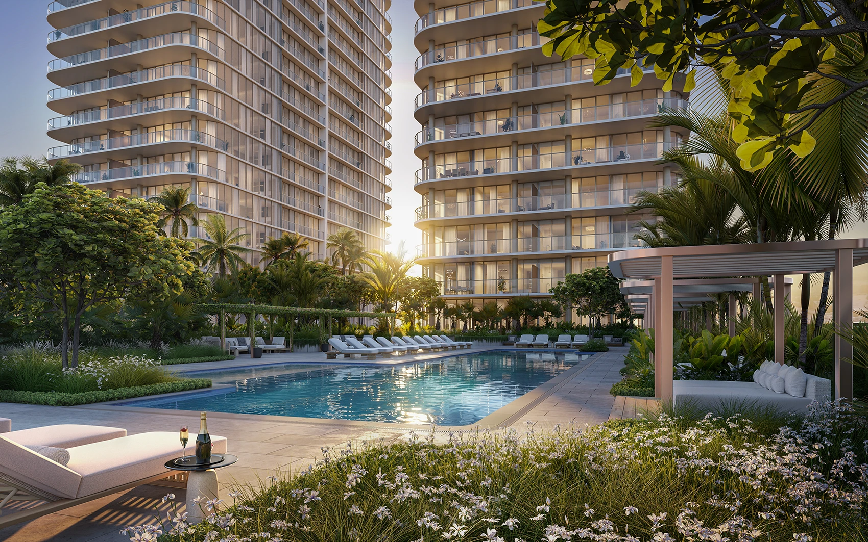 North pool area at Kempinski Residences Miami Design District with lounge seating, cabanas, tropical landscaping, and residential towers