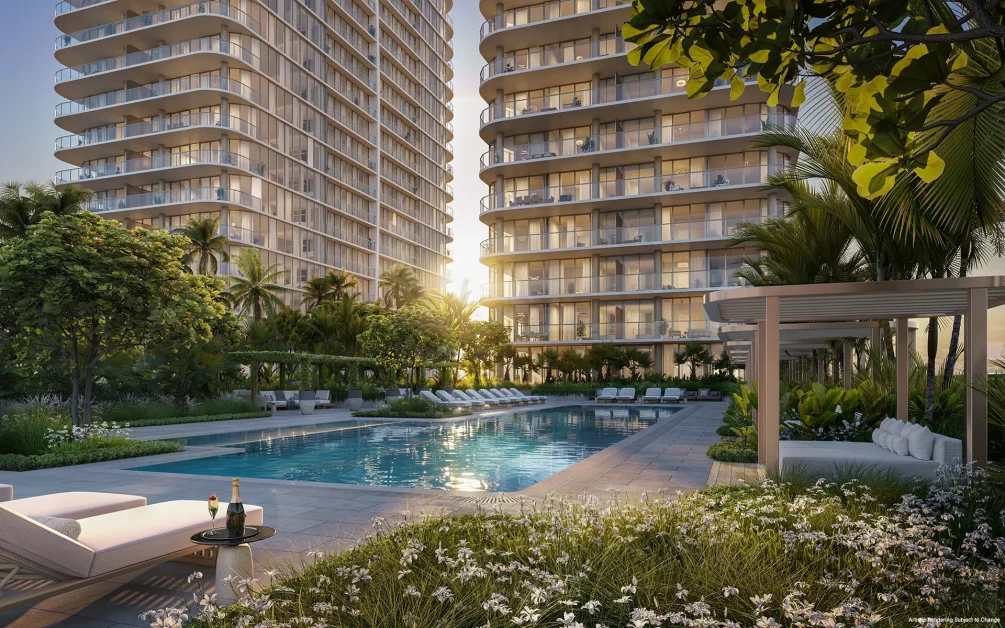 Luxury resort-style swimming pool surrounded by tropical landscaping and residential towers