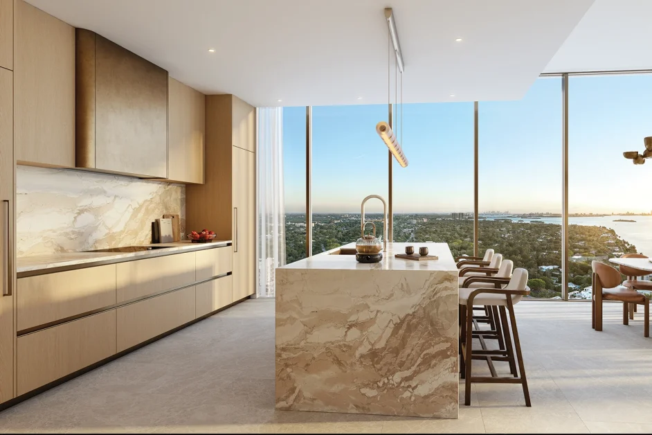 Luxury kitchen at Kempinski Residences Miami Design District with marble island, warm wood cabinetry, and bay views
