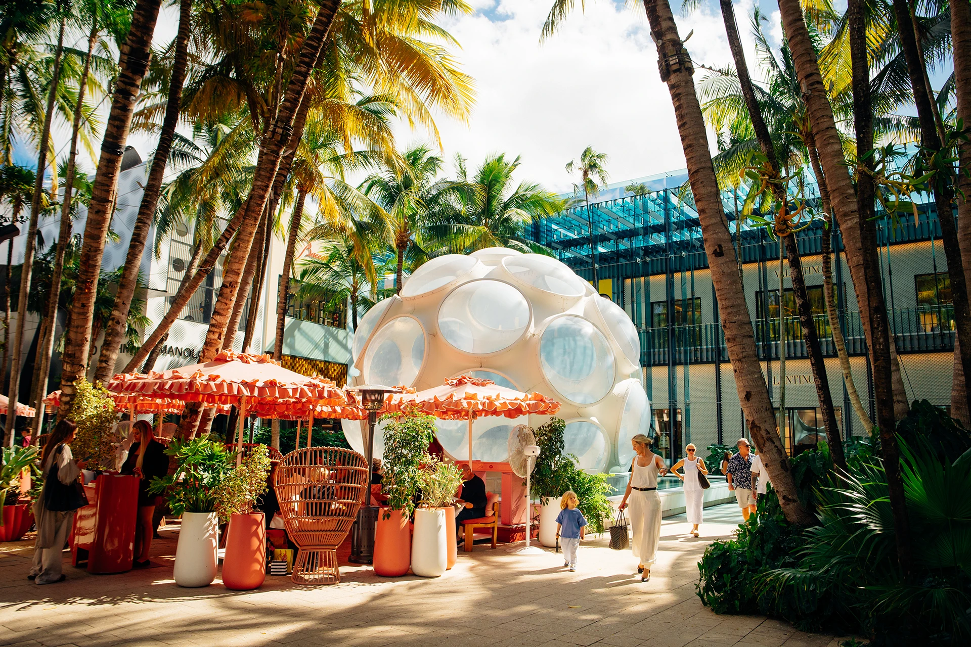 Buckminster Fuller Fly’s Eye Dome in the Miami Design District surrounded by palm trees, outdoor dining, and luxury boutiques