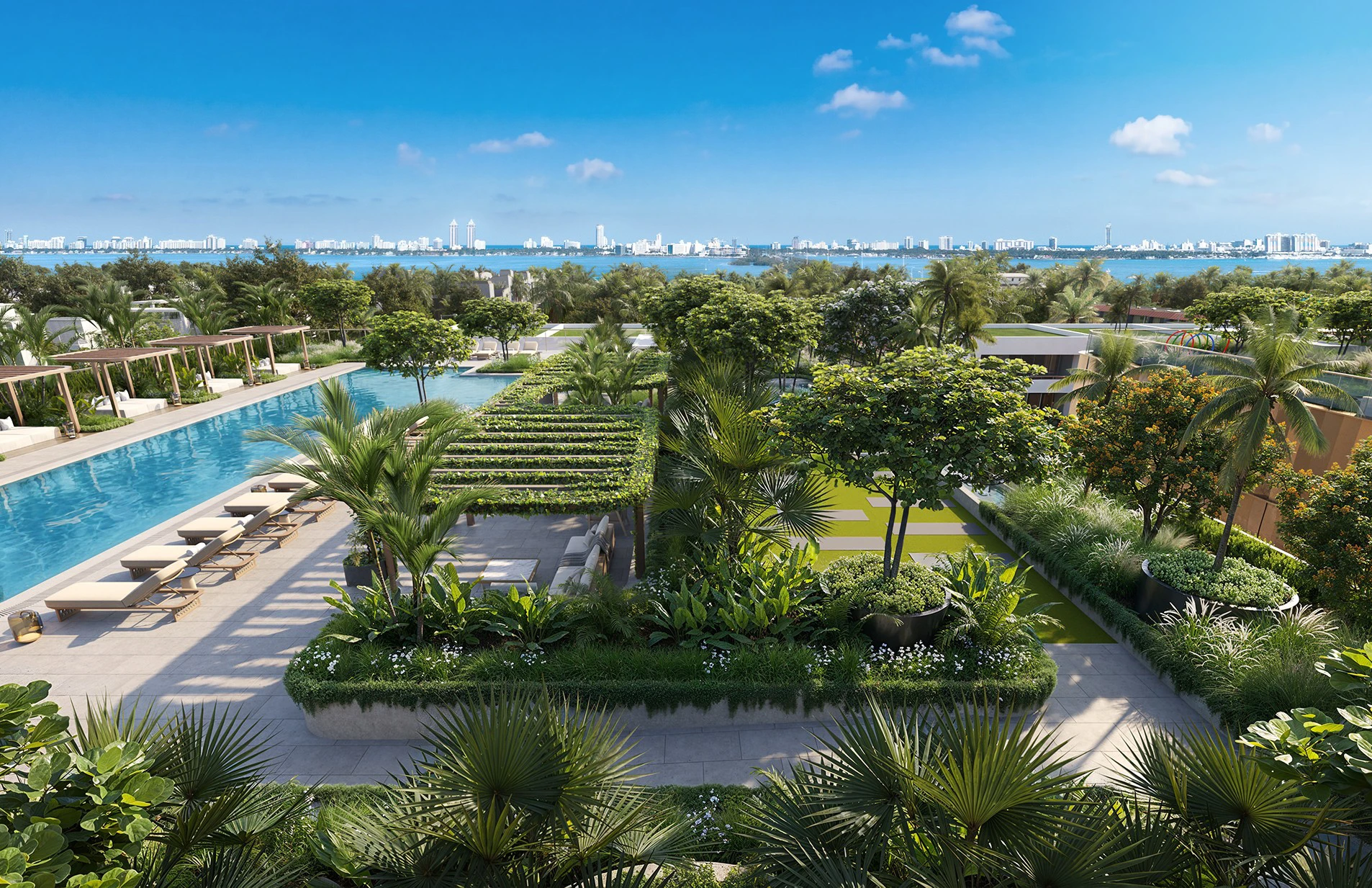 North seating area at Kempinski Residences Miami Design District with pool, tropical landscaping, cabanas, and Biscayne Bay views
