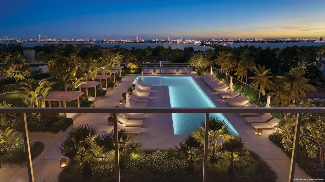 South pool area at Kempinski Residences Miami Design District illuminated at evening with Biscayne Bay and Miami skyline views