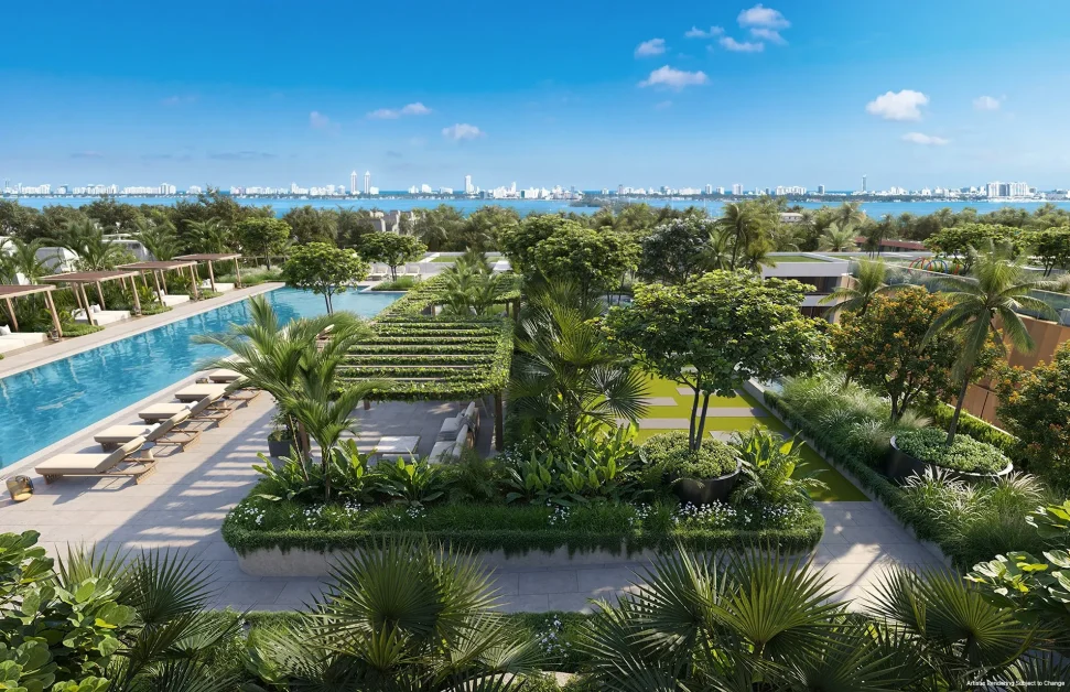 North seating area at Kempinski Residences Miami Design District with pool, tropical landscaping, cabanas, and Biscayne Bay views