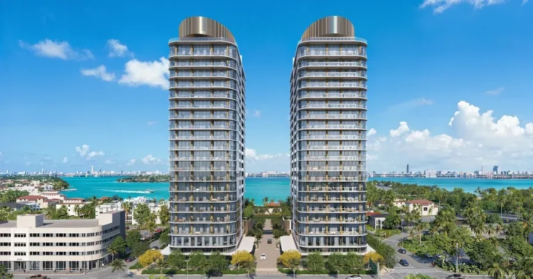 Twin luxury residential towers rise above Miami's Biscayne Bay waterfront, featuring curved glass facades, private balconies, and panoramic views of turquois...