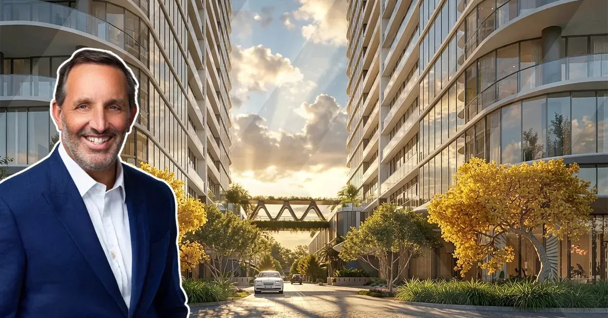 A smiling real estate professional in a navy blazer poses before a luxury high-rise development featuring golden trees, curved glass towers, and an elegant a...