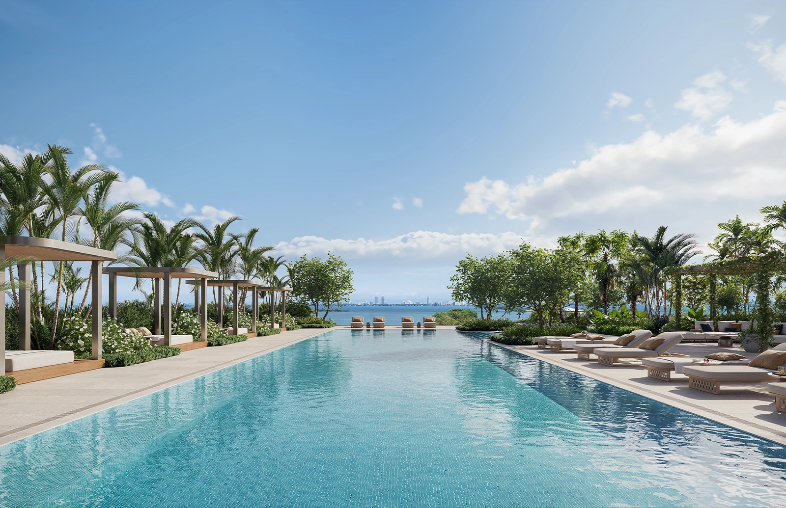 South pool area at Kempinski Residences Miami Design District with lounge chairs, umbrellas, tropical landscaping, and palm trees