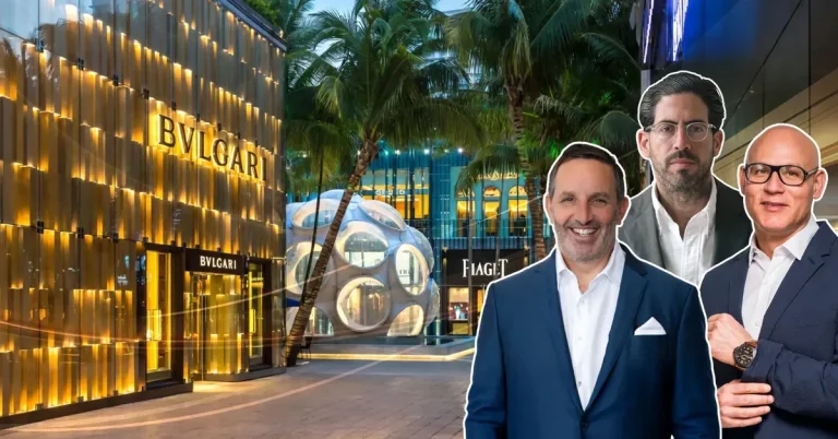 Three real estate executives pose in front of Miami's Design District luxury retail corridor, featuring the iconic Bvlgari and Piaget storefronts.