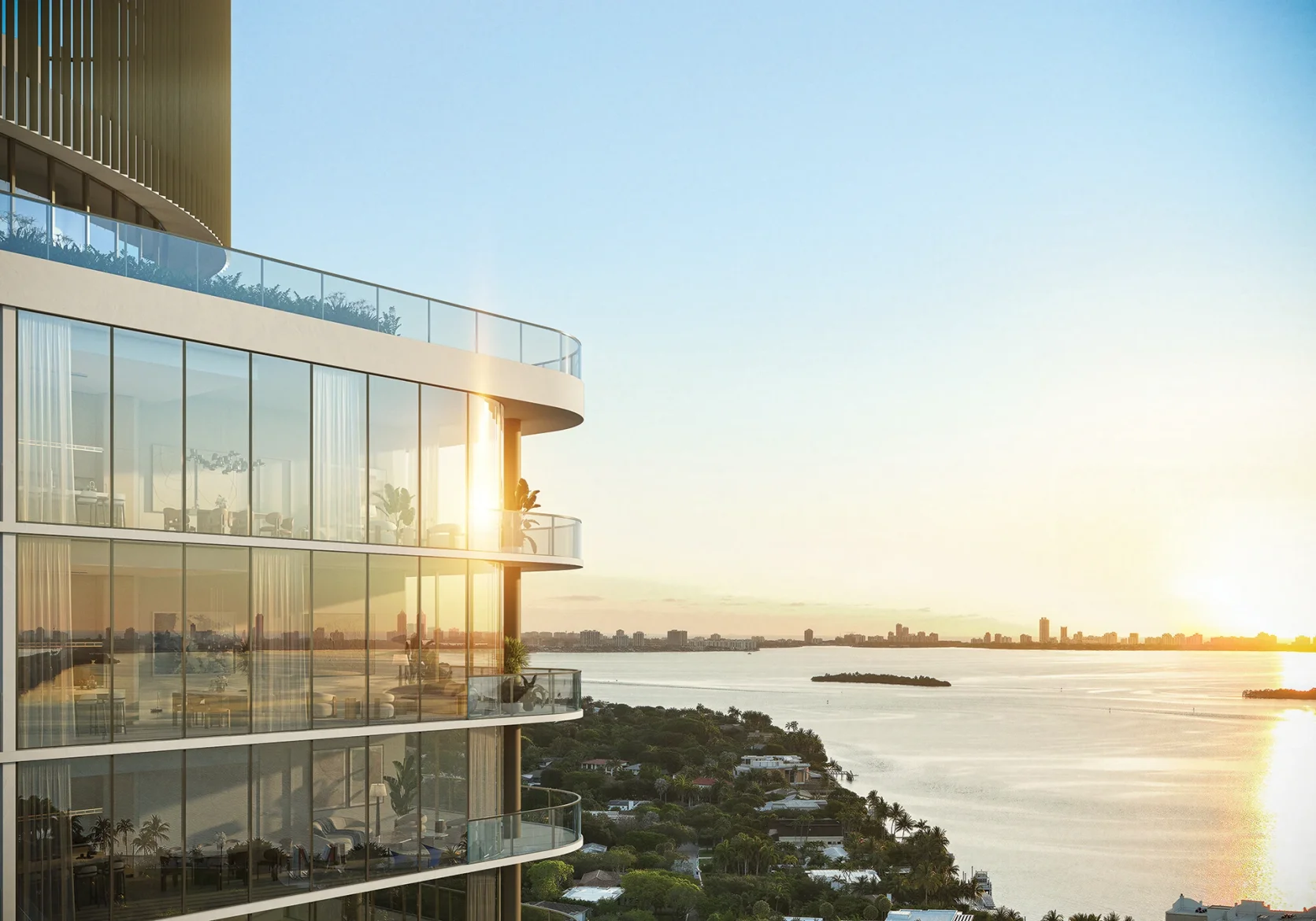 Kempinski Residences Miami Design District tower with glass terraces overlooking Biscayne Bay at sunset