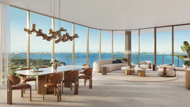 Kempinski Residences Miami Design District living room with dining area, floor-to-ceiling windows, and Biscayne Bay views